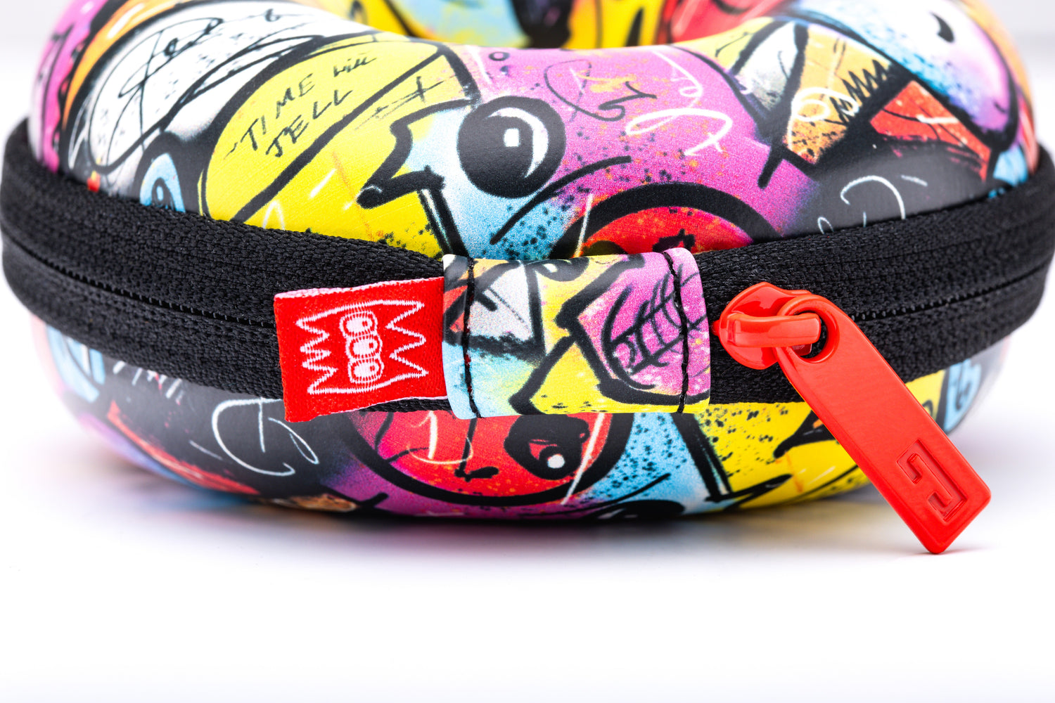 Colorful graffiti-patterned case with a red zipper on a white background